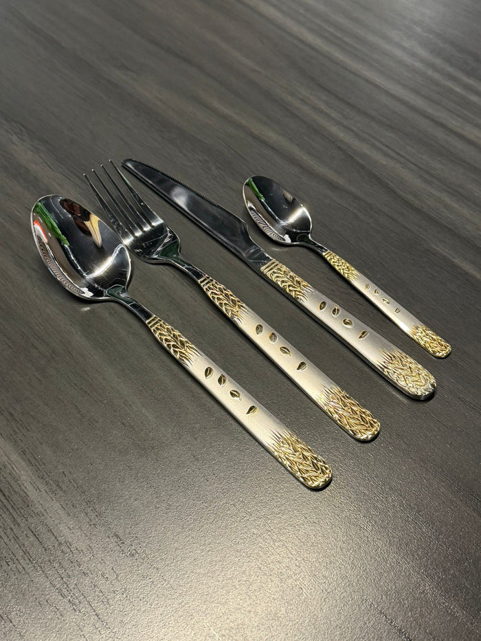 Premium stainless steel cutlery set with decorative gold-pattern handles including spoon, fork, knife, and teaspoon for catering and hospitality use.